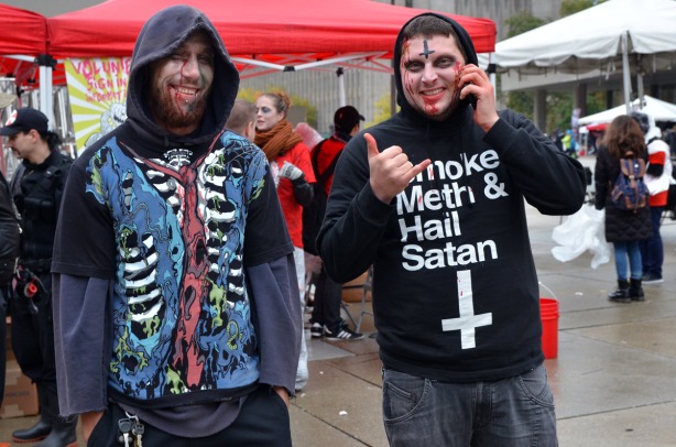 Two men.  The one on the right is wearing a hoodie that says smoke meth and hail satan.