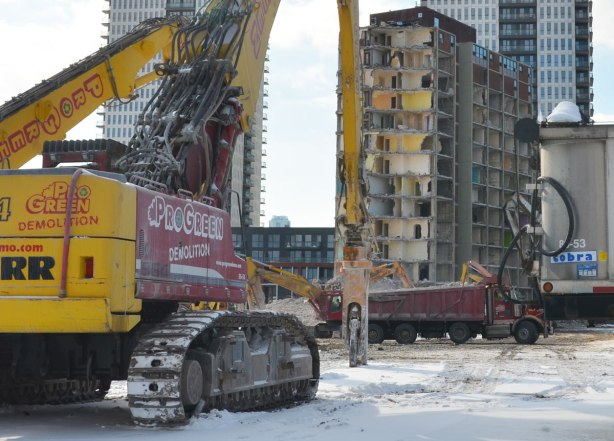 Hydraulic crane and truck and other machinery used in the demolition of the building.  
