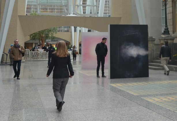 A picture taken inside the Allan Lambert Gallery at Brookfield Place, photos by Sjoerd Knibbeler, a series called Current Study large pictures standing in the middle of the gallery, as well as series called "Paper Planes" which are hung from the ceiling