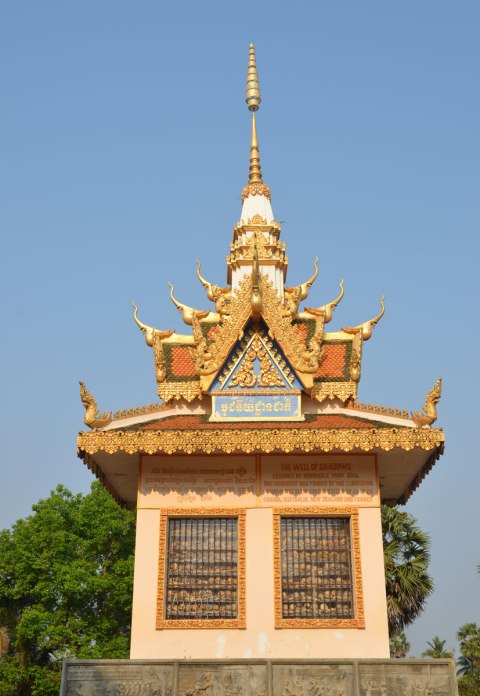 top part of a stupa, pagoda shaped, glass window in the side where you cansee the bones of dead people