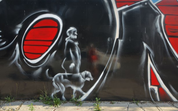 part of a mural, man walking a dog 