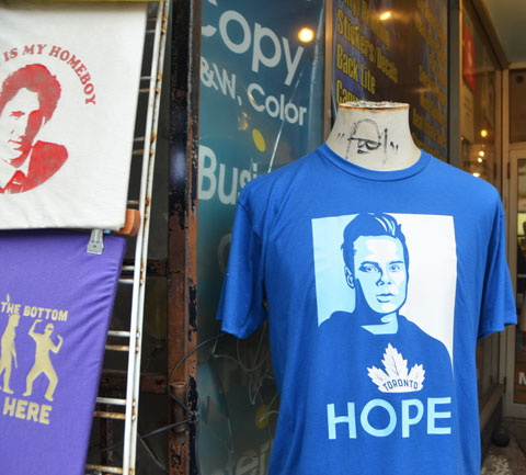 in front of a store that seels T-shirts, a blue T-shirt based on the famous Obama Hope poster, but this time the portrait is of a Maple Leaf player with the word hope below. 