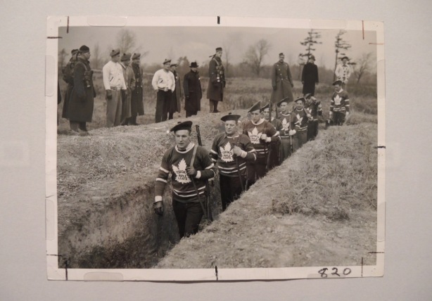 vintage photo of men in Maple Leafs hockey sweaters walking through war trenches