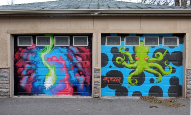 two garage doors with murals of marine life, a squid on the left and an octopus on the right. 
