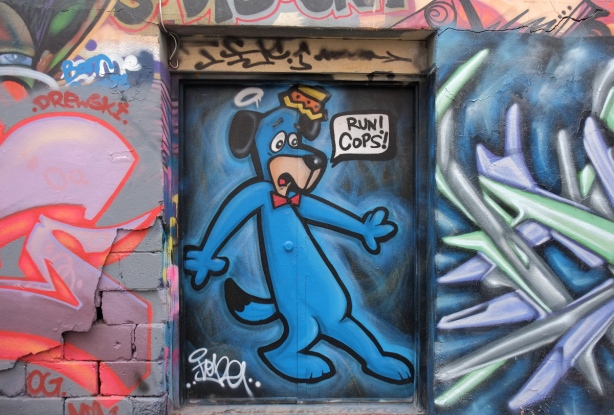mural in Graffiti Alley - cartoon dog in blue on door, with words run cops!