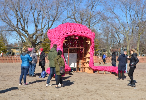 large oversized pink pussy hat as an art installation on the beach 