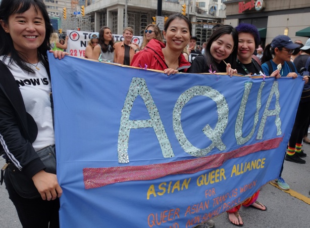 dyke march 2018 - Asian women holding a blue banner that says Aqua, Asian Queer Alliance, 5 women holding the banner 