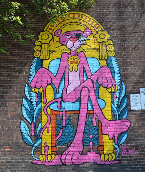 mural of pink panther sitting in a chair, large