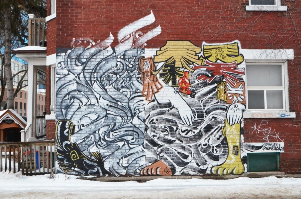 large mural on the side of a red brick house