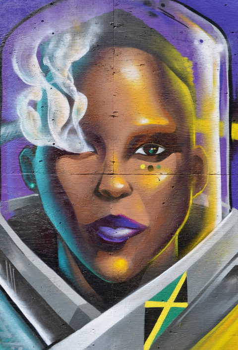 black woman's head in space helmet of clear glass, futuristic clothing around her neck, Jamaican flag painted on her collar, purple lips