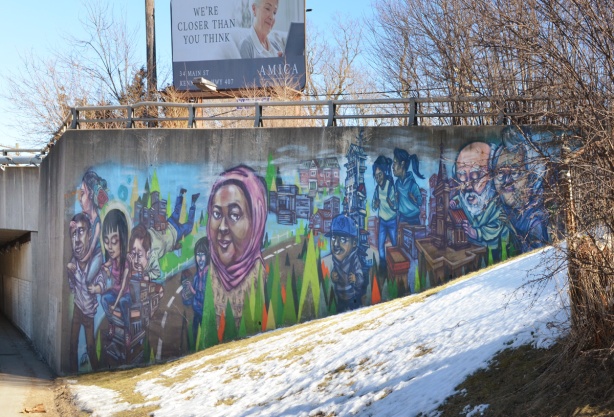 mural by elicser on the concrete wall of a C P R overpass in Scarborough
