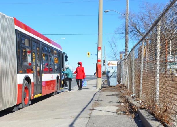two women getting on a Sheppard TTC bus at Midland