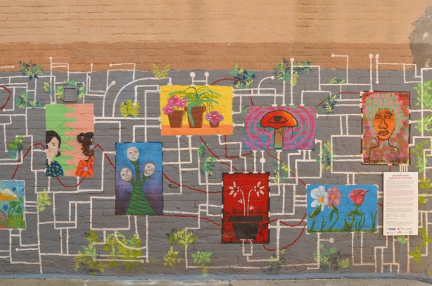 girls camp mural in an alley near Hamilton Street in Toronto, poster like pictures connected with white lines like a schmetic drawing