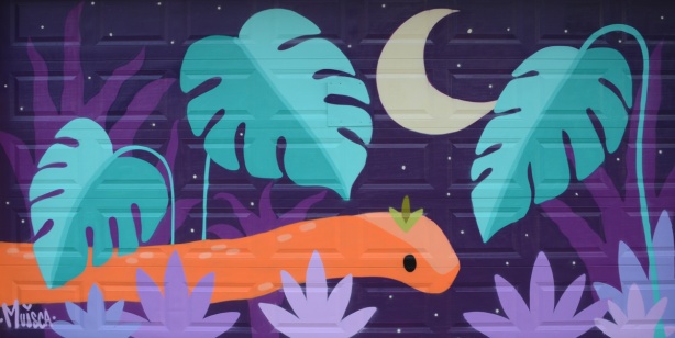 a mural by muisca on a garage door in a lane, an orange snake in the purple night with moon and plant with large leaves
