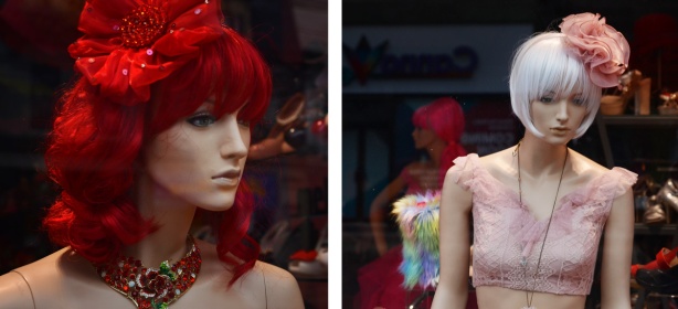 two images of mannequins in a window, one in pink and the other in red with red hair, both with large bows in their hair 