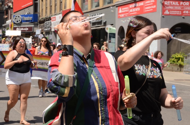person blowing bubbles, dyke march