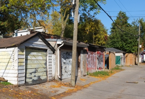 alley view, line of garages with utility poles