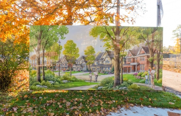 development imagining of housing in large picture beside a new development, large single family homes with large trees, with real trees and grass surrounding the picture