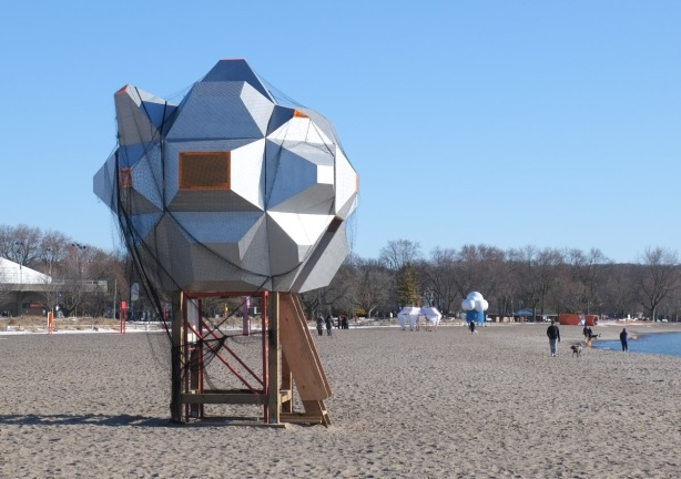 public art, winter stations, on Woodbine beach, supposed to look like UFO that landed on the beach, covered with netting