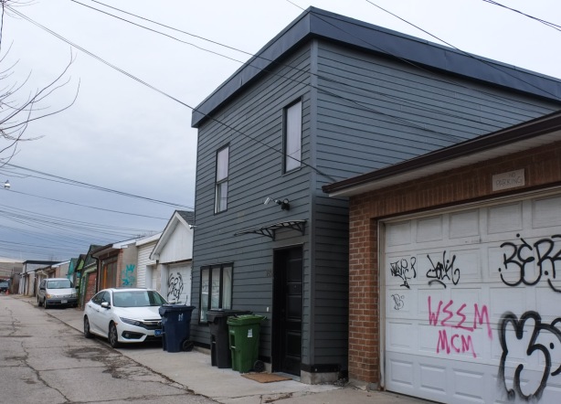 black clad two storey house, dwelling, infill in an alley 