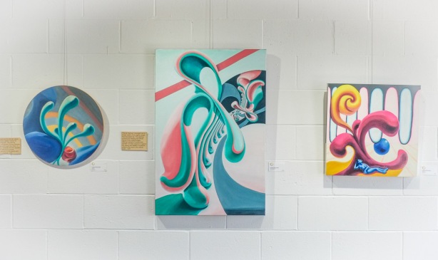 three paintings by Natalie Plociennik, one round one, one vertical rectangle, and one square, abstracts, curvy shapes 