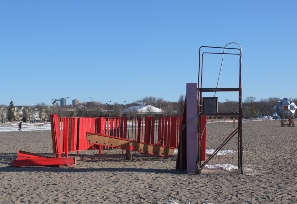 winter station called bobbin on woodbine beach, red wood fence around a teeter totter