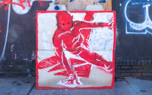 red on white painting of a break dancer, graffiti