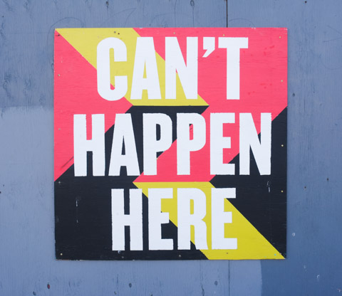graffiti signs by Nigel Smith, with words that say can't happen here