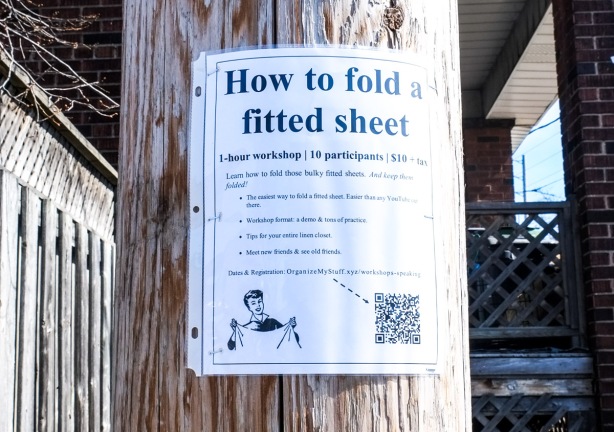 poster on wood utility pole with the title How to fold a fitted sheet