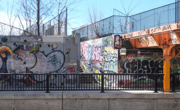 entrance to toronto railpath beside tracks on Bloor Street, concrete walls covered in graffiti