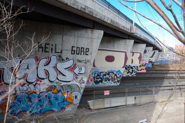 concrete supports under bridge, Bloor Street over railway tracks, covered with graffiti,