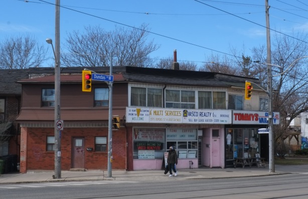 southwest corner of Sorauren and Dundas West, building with large white sign and pink features