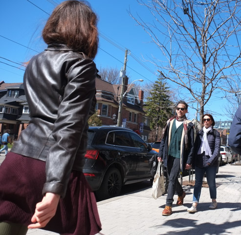 walking on Roncesvalles, a woman in a maroon skirt, a couple walking together